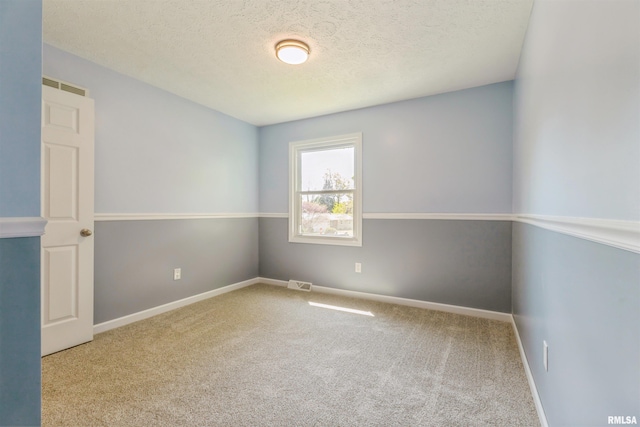 1960 Tam-O-Shanter Dr, Bettendorf, IA 52722 - carpeted spare room with a textured ceiling and baseboards