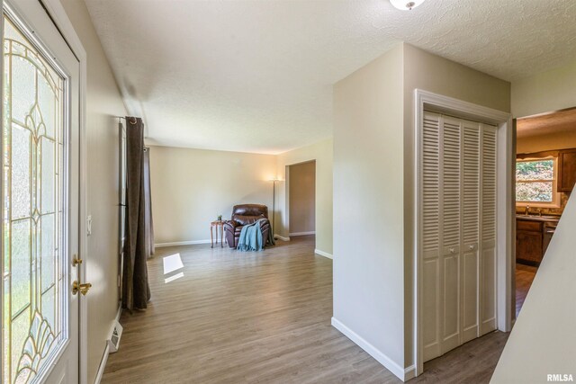 1960 Tam-O-Shanter Dr, Bettendorf, IA 52722 - corridor featuring baseboards, wood finished floors, a sink, and a textured ceiling