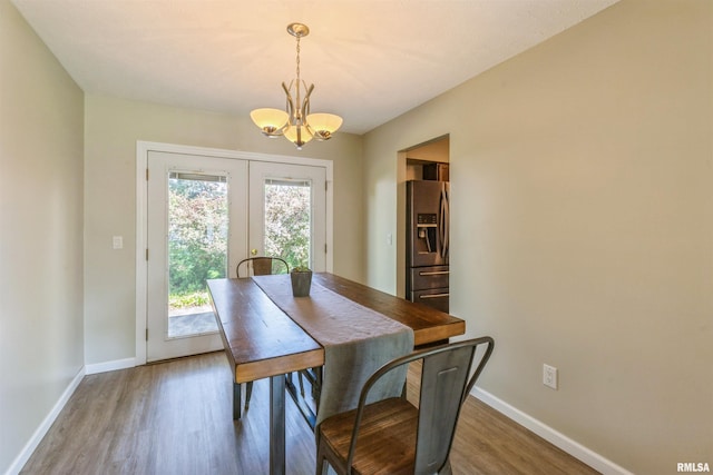 1960 Tam-O-Shanter Dr, Bettendorf, IA 52722 - dining space featuring a chandelier, wood finished floors, baseboards, and french doors