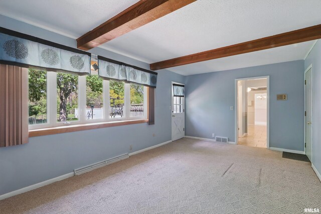 carpeted empty room featuring beamed ceiling, baseboard heating, and baseboards