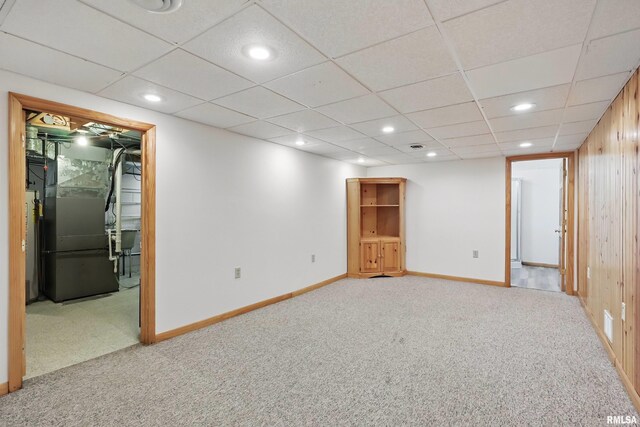 finished basement with carpet flooring, heating unit, recessed lighting, and baseboards
