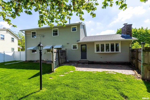 back of property featuring a chimney, entry steps, and a patio
