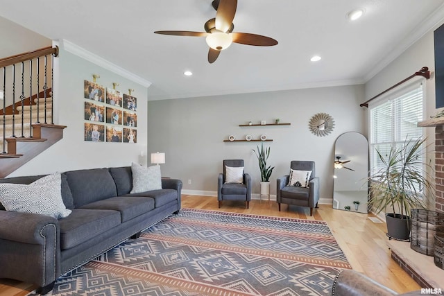 living room featuring ceiling fan, wood finished floors, stairs, recessed lighting, and crown molding