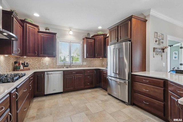 kitchen with appliances with stainless steel finishes, a sink, ornamental molding, decorative backsplash, and light countertops