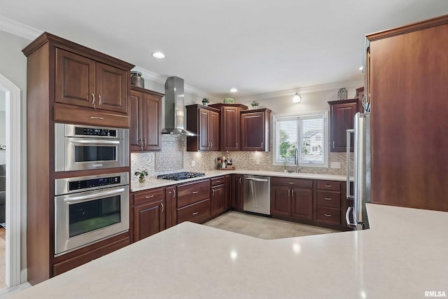 kitchen with wall chimney exhaust hood, appliances with stainless steel finishes, ornamental molding, tasteful backsplash, and light countertops
