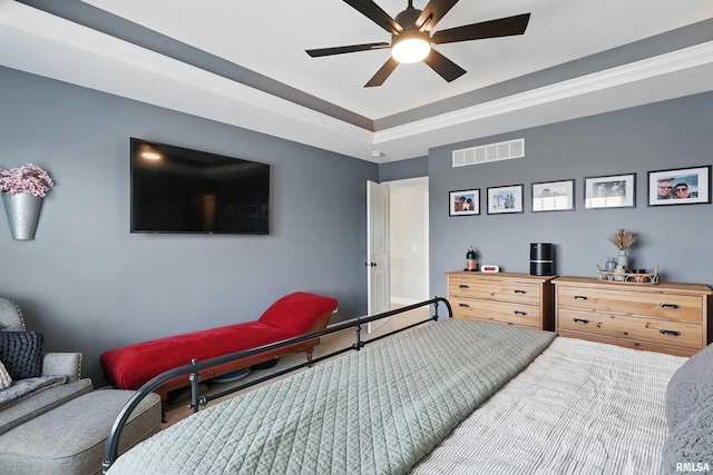 bedroom featuring a ceiling fan and a raised ceiling