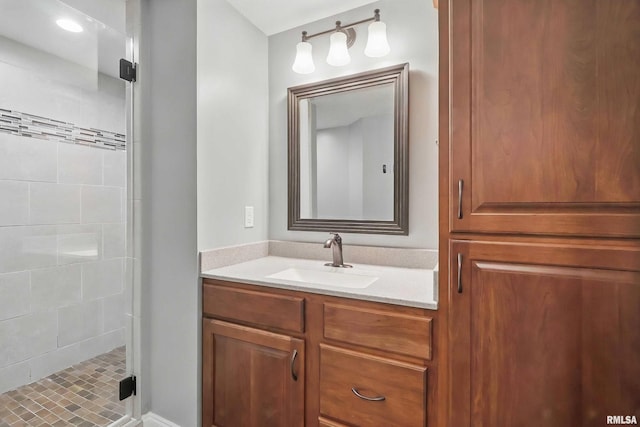 bathroom featuring a shower stall and vanity