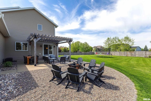 view of yard with a trampoline, a pergola, a patio, and an outdoor living space with a fire pit