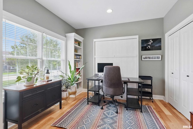 office space featuring light wood-style floors, recessed lighting, and baseboards