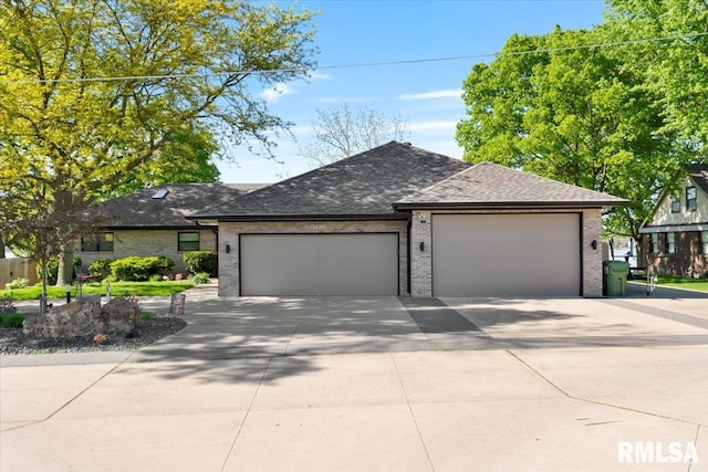 view of front of property with an attached garage, driveway, brick siding, and a shingled roof