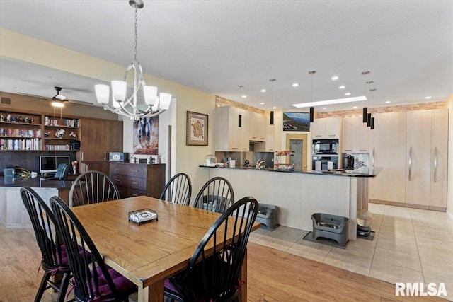 dining area featuring a chandelier, ceiling fan, light tile patterned floors, and recessed lighting