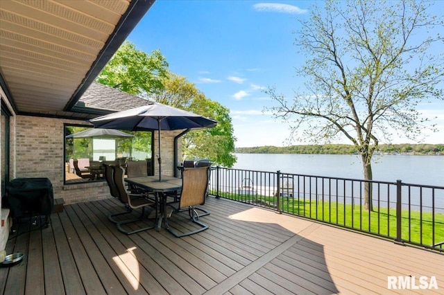 deck featuring outdoor dining space and a water view