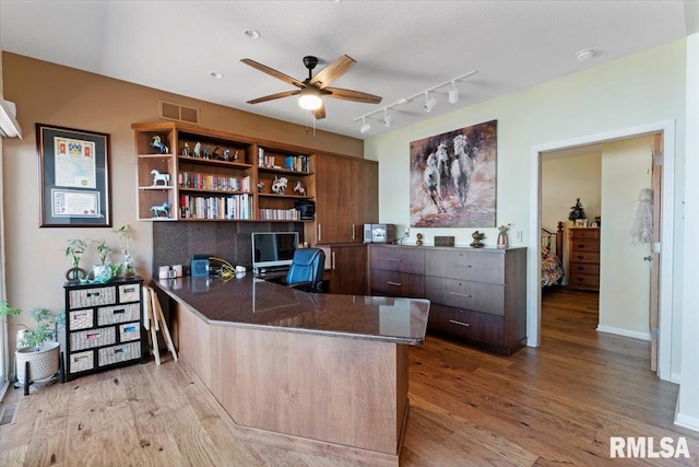 office featuring ceiling fan, wood finished floors, and rail lighting