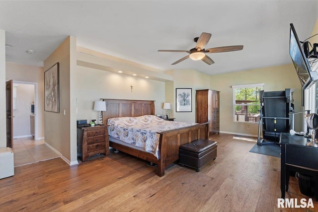 bedroom featuring baseboards, wood finished floors, and ceiling fan