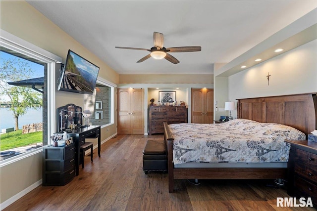 bedroom with baseboards, wood finished floors, and a ceiling fan