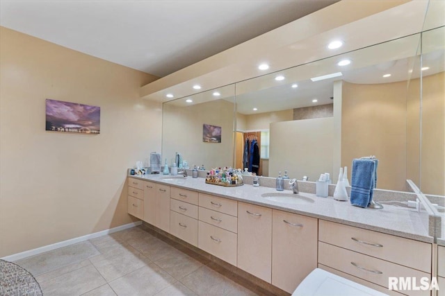 bathroom with double vanity, baseboards, recessed lighting, and tile patterned floors