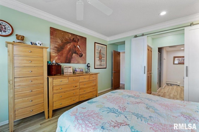 bedroom featuring ornamental molding, light wood finished floors, a baseboard heating unit, baseboards, and ceiling fan