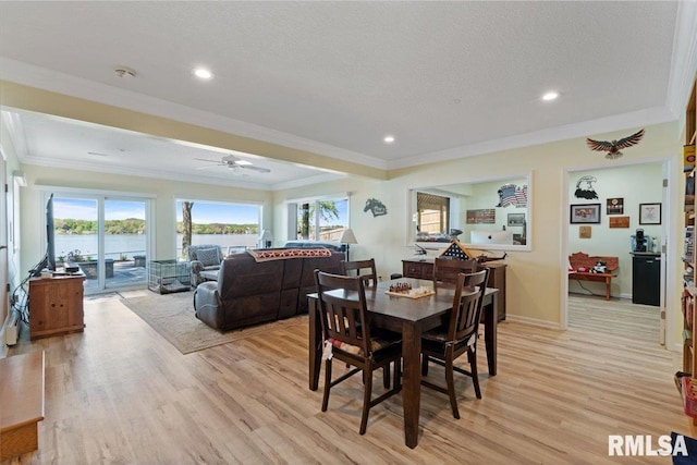 dining space with ornamental molding, light wood-type flooring, plenty of natural light, ceiling fan, and recessed lighting