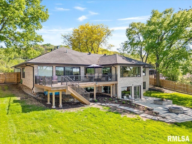 rear view of property with a fire pit, stairway, a wooden deck, a patio, and a shingled roof