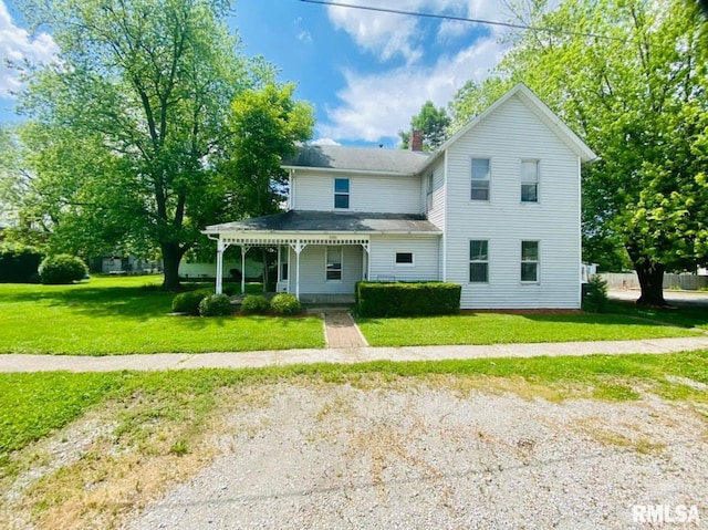1202 17th Ave, Viola, IL 61486 - view of front facade with a porch, a front yard, and a chimney