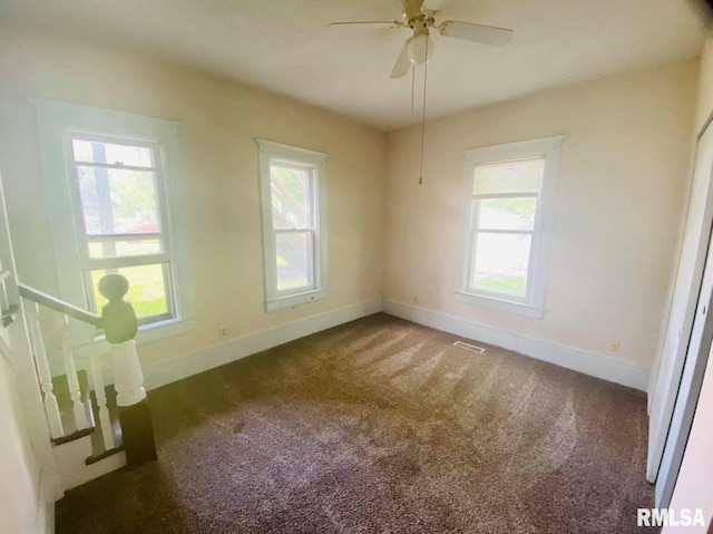 1202 17th Ave, Viola, IL 61486 - spare room featuring baseboards, carpet flooring, and a ceiling fan