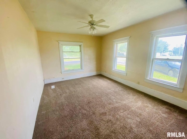 1202 17th Ave, Viola, IL 61486 - unfurnished room with baseboards, carpet flooring, and ceiling fan