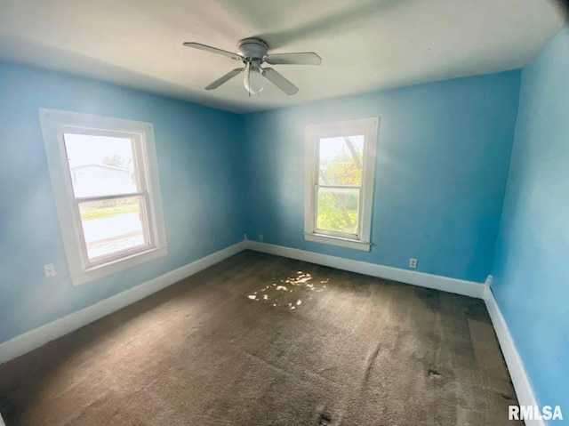 1202 17th Ave, Viola, IL 61486 - unfurnished room with baseboards, carpet flooring, and ceiling fan