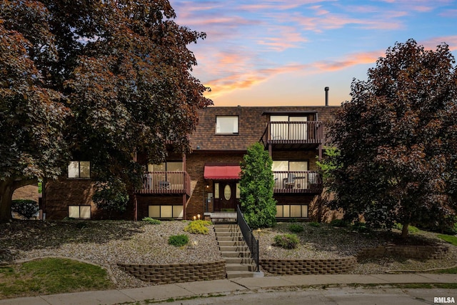 2505 26th Avenue Ct Unit J, Rock Island, IL 61201 - view of front of house with stairway, mansard roof, a balcony, and brick siding