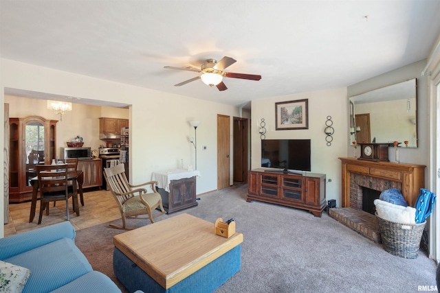 2505 26th Avenue Ct Unit J, Rock Island, IL 61201 - living area featuring a chandelier, a brick fireplace, a ceiling fan, and light colored carpet