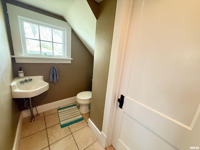 101 S Stewart St, Geneseo, IL 61254 - half bathroom featuring toilet, tile patterned flooring, baseboards, and lofted ceiling