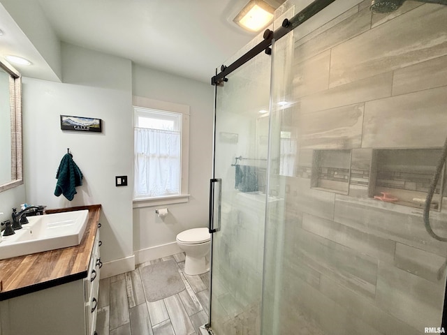 101 S Stewart St, Geneseo, IL 61254 - bathroom featuring baseboards, a stall shower, toilet, and vanity