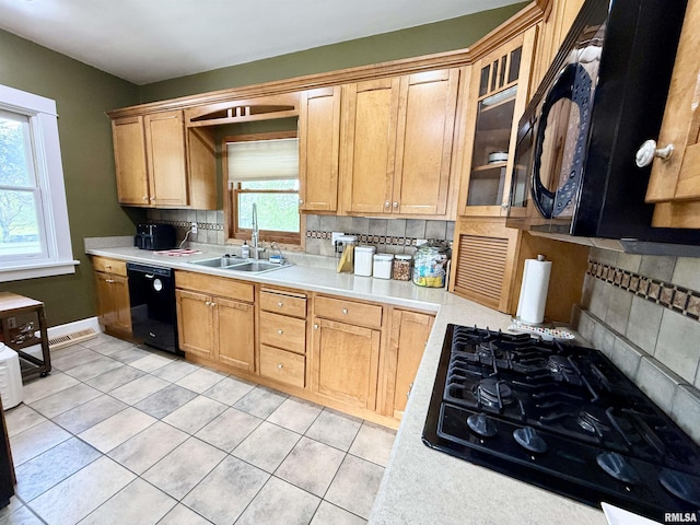 101 S Stewart St, Geneseo, IL 61254 - kitchen with a sink, black appliances, and tasteful backsplash