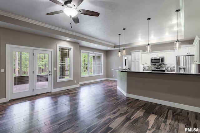 3972 Baptist Camp Rd, Carterville, IL 62918 - unfurnished living room with crown molding, baseboards, a raised ceiling, dark wood-type flooring, and a ceiling fan