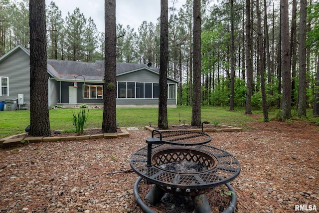 3972 Baptist Camp Rd, Carterville, IL 62918 - view of green lawn featuring a fire pit and a sunroom
