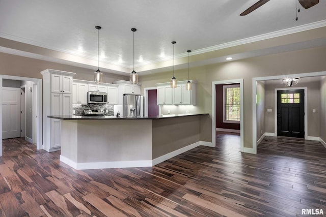 3972 Baptist Camp Rd, Carterville, IL 62918 - kitchen with appliances with stainless steel finishes, dark countertops, ornamental molding, white cabinets, and dark wood-style floors