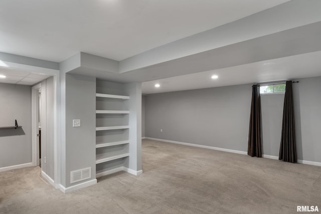 basement featuring carpet flooring, baseboards, recessed lighting, and built in features