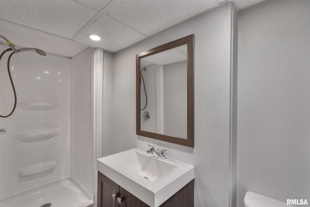 full bath with a stall shower, toilet, vanity, recessed lighting, and a paneled ceiling