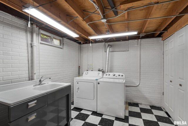 laundry area featuring dark flooring and separate washer and dryer