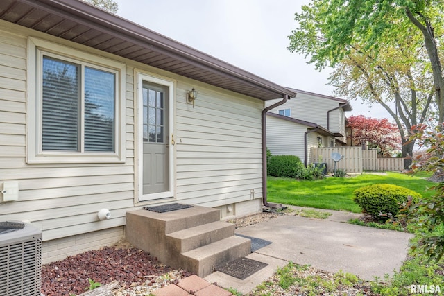 doorway to property with central AC unit and a patio