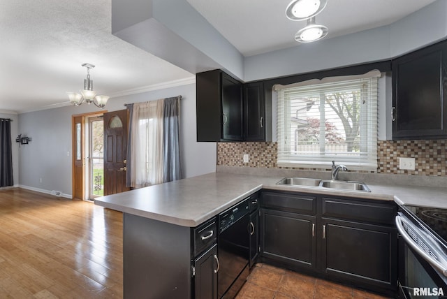 kitchen featuring a sink, dishwasher, stainless steel range with electric cooktop, a peninsula, and decorative backsplash