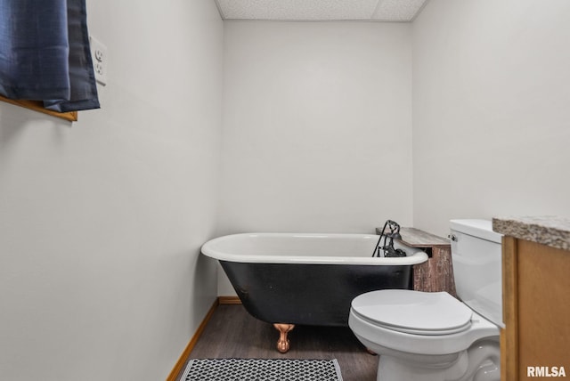 1709 Main St, Keithsburg, IL 61442 - full bathroom featuring toilet, a soaking tub, wood finished floors, and baseboards