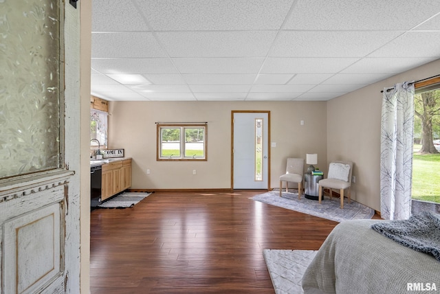 1709 Main St, Keithsburg, IL 61442 - living area with dark wood-type flooring, a paneled ceiling, and baseboards
