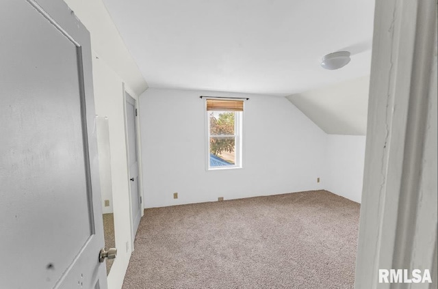 bonus room with carpet flooring and vaulted ceiling