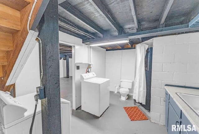 unfinished basement with a sink and concrete block wall