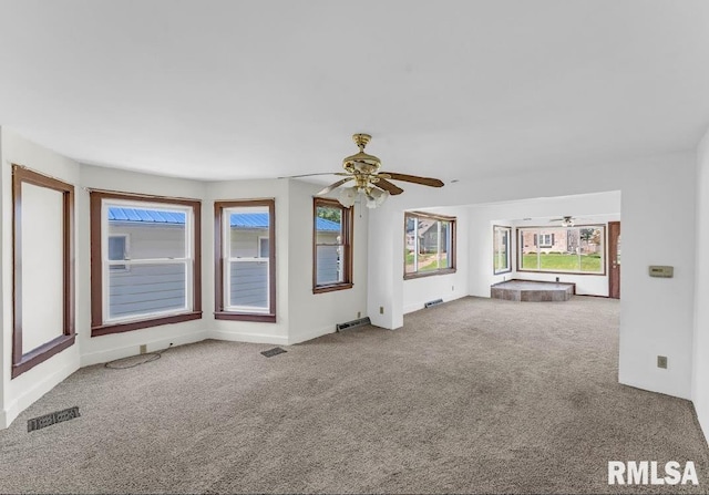 unfurnished living room featuring a ceiling fan and carpet flooring