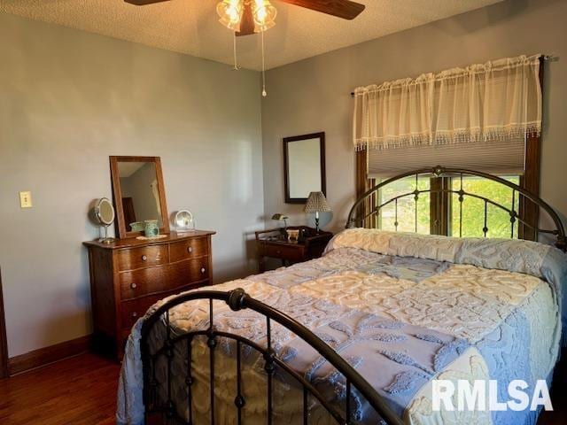 bedroom with wood finished floors, baseboards, and a ceiling fan