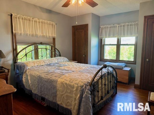 bedroom featuring wood finished floors and a ceiling fan