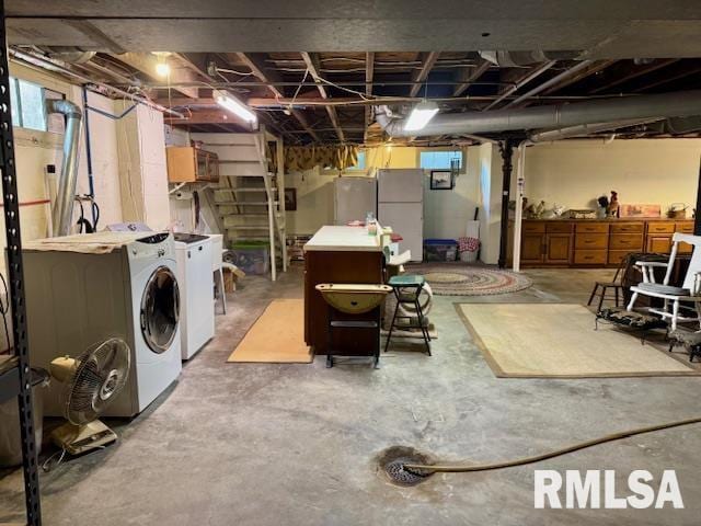 below grade area with washer and clothes dryer and freestanding refrigerator