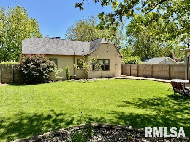 back of property featuring stucco siding
