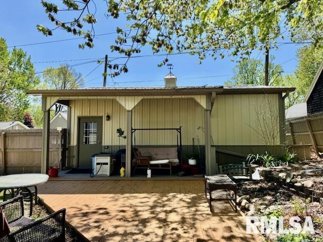 back of property with fence and a patio area